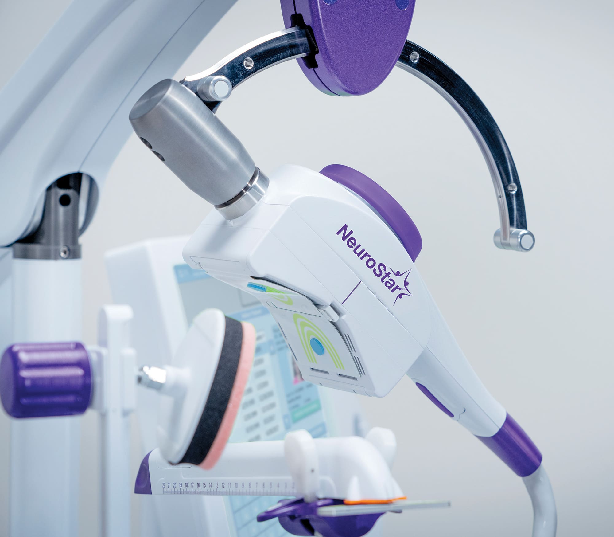 Close-up of a NeuroStar TMS treatment coil used for non-invasive brain stimulation.